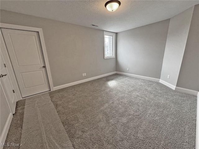 32054 Tuscan Ln Unit L-2, Avon Lake, OH 44012 - empty room featuring a textured ceiling and carpet
