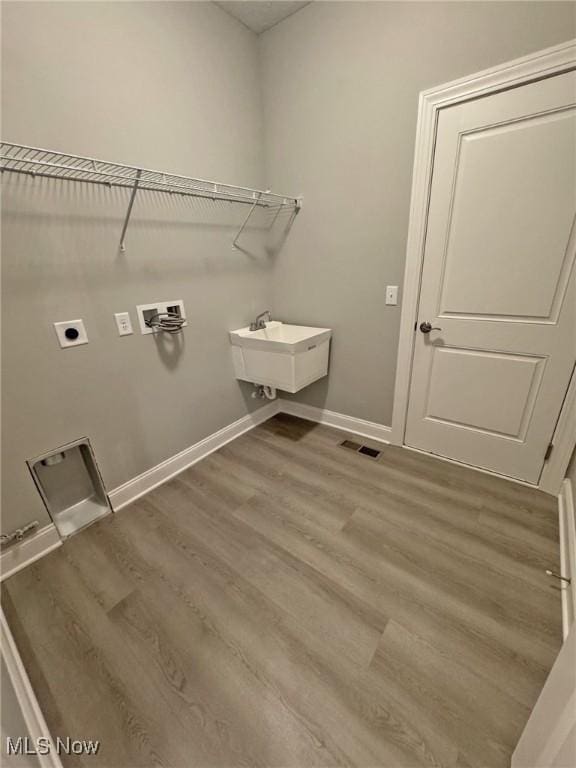 32054 Tuscan Ln Unit L-2, Avon Lake, OH 44012 - laundry room featuring washer hookup, wood finished floors, and hookup for an electric dryer