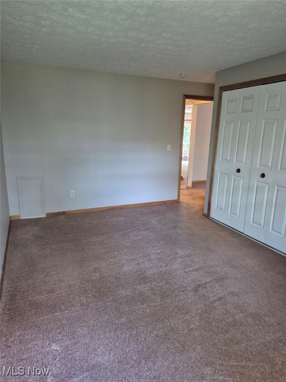 4360 Inner Circle Dr Unit C14, Brunswick, OH 44212 - unfurnished bedroom with a textured ceiling, carpet floors, and a closet
