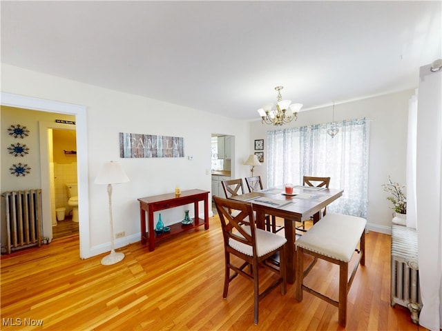 1907 Robindale St, Wickliffe, OH 44092 - dining room featuring radiator, a chandelier, and light wood-style floors