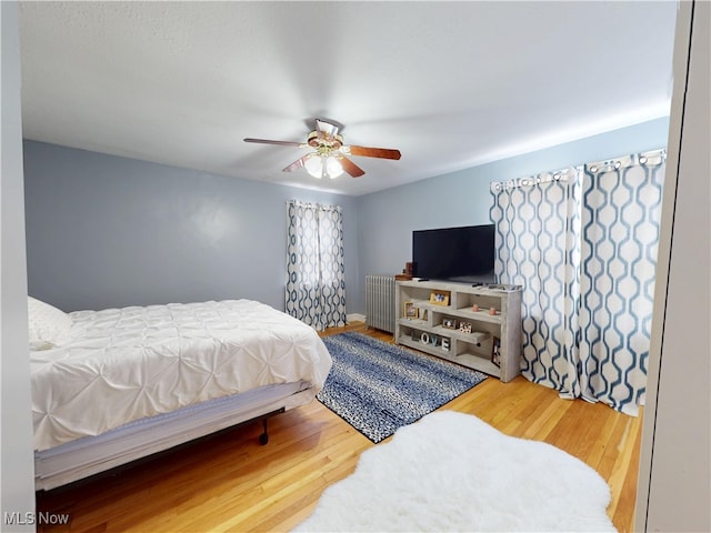 1907 Robindale St, Wickliffe, OH 44092 - bedroom featuring radiator heating unit, wood finished floors, and a ceiling fan