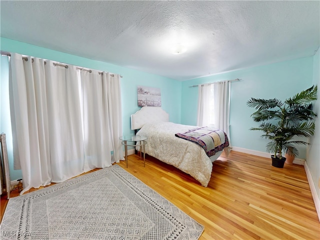 1907 Robindale St, Wickliffe, OH 44092 - bedroom with wood finished floors and a textured ceiling