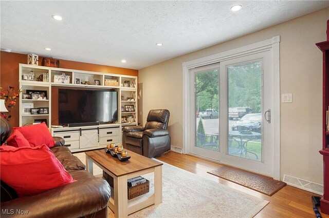 13 S River Rd, Munroe Falls, OH 44262 - living area with wood finished floors, recessed lighting, and a textured ceiling
