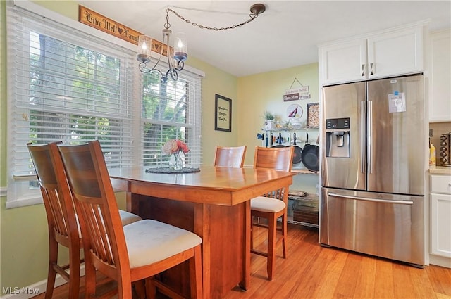 13 S River Rd, Munroe Falls, OH 44262 - dining area with light wood-style floors and a chandelier