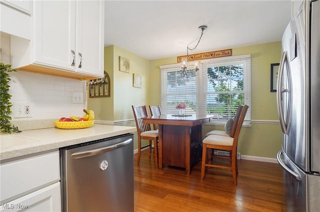 13 S River Rd, Munroe Falls, OH 44262 - kitchen with stainless steel appliances, tasteful backsplash, white cabinetry, and dark wood-type flooring