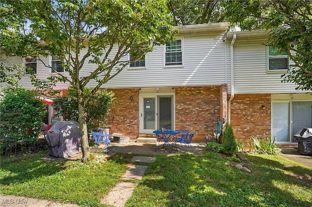 13 S River Rd, Munroe Falls, OH 44262 - rear view of house with brick siding, a yard, and a patio
