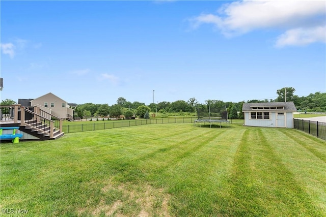 2979 Cloverhurst St NE, Canton, OH 44721 - fenced backyard featuring a trampoline, a storage unit, and a view of rural / pastoral area