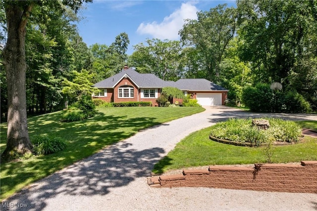 10400 Stoneacre St NW, Canal Fulton, OH 44614 - ranch-style home featuring gravel driveway, an attached garage, a front lawn, and brick siding