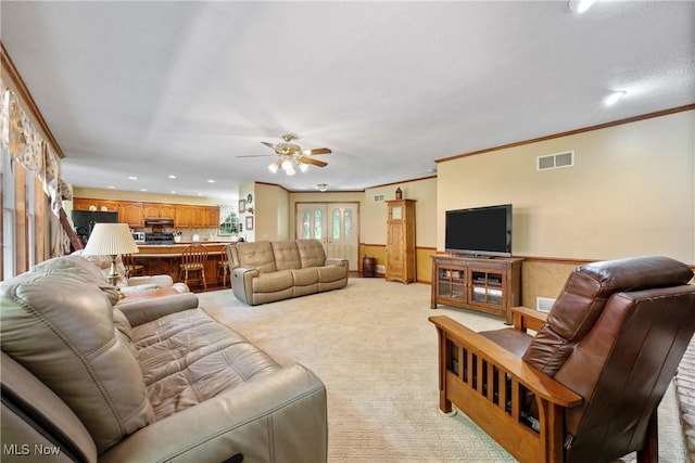 10400 Stoneacre St NW, Canal Fulton, OH 44614 - living area with a ceiling fan, recessed lighting, light colored carpet, wainscoting, and crown molding