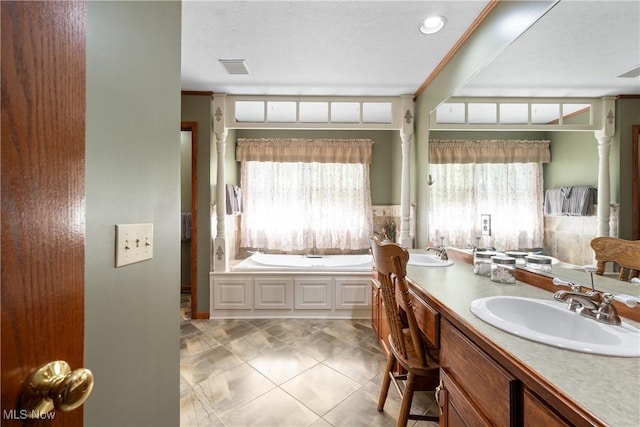 10400 Stoneacre St NW, Canal Fulton, OH 44614 - bathroom featuring double vanity, a bath, and a textured ceiling