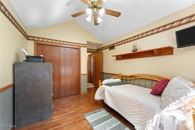 10400 Stoneacre St NW, Canal Fulton, OH 44614 - bedroom with vaulted ceiling, wood finished floors, and a ceiling fan