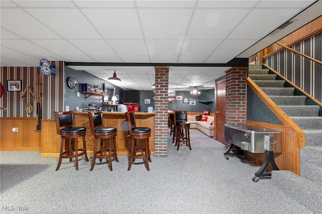 10400 Stoneacre St NW, Canal Fulton, OH 44614 - indoor bar featuring carpet floors, a paneled ceiling, wood walls, and stairway