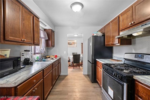 127 Brush Rd, Richmond Heights, OH 44143 - kitchen with black appliances, under cabinet range hood, and light wood-style floors