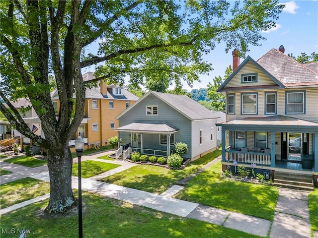 813 3rd St, Marietta, OH 45750 - victorian home featuring a porch, a chimney, and a front lawn