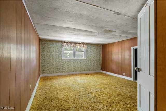 813 3rd St, Marietta, OH 45750 - carpeted empty room with wallpapered walls and wooden walls