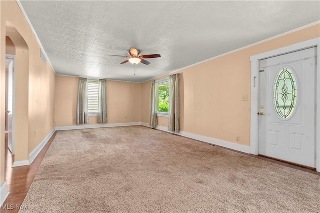 813 3rd St, Marietta, OH 45750 - entrance foyer with ceiling fan, ornamental molding, a textured ceiling, and carpet