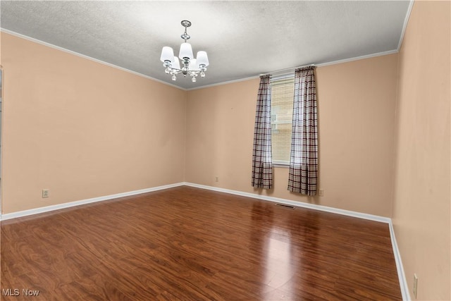 813 3rd St, Marietta, OH 45750 - spare room featuring wood finished floors, a chandelier, crown molding, and a textured ceiling