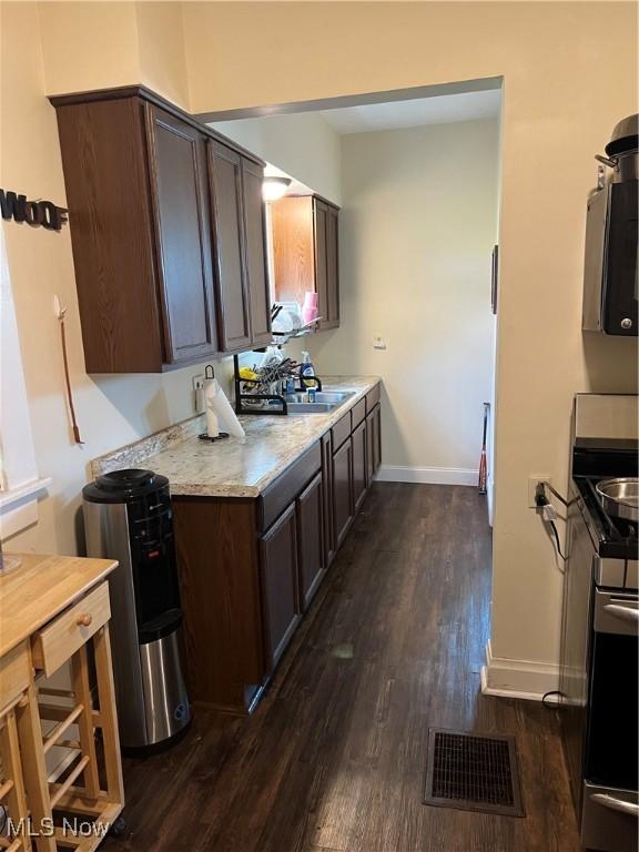 13 Neil St, Niles, OH 44446 - kitchen featuring dark brown cabinetry, dark wood-style floors, and stainless steel range oven