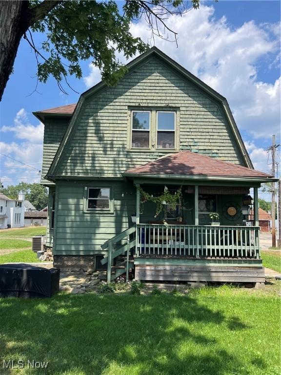 13 Neil St, Niles, OH 44446 - back of house with a gambrel roof, a lawn, and covered porch