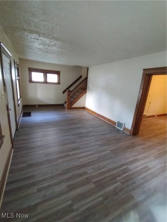 207 E Lucius Ave, Youngstown, OH 44507 - unfurnished living room featuring wood finished floors and stairs
