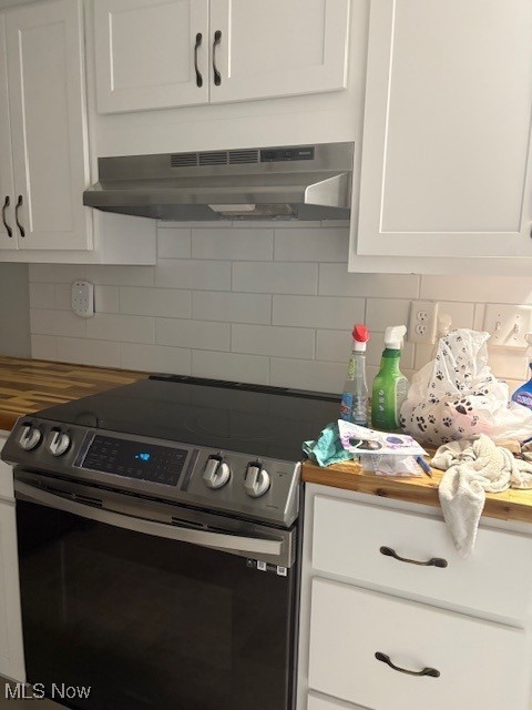206 Fowler, Cortland, OH 44410 - kitchen featuring stainless steel electric stove, under cabinet range hood, white cabinetry, and tasteful backsplash
