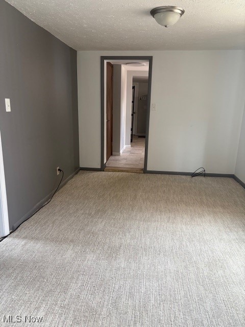 206 Fowler, Cortland, OH 44410 - unfurnished room with light colored carpet and a textured ceiling