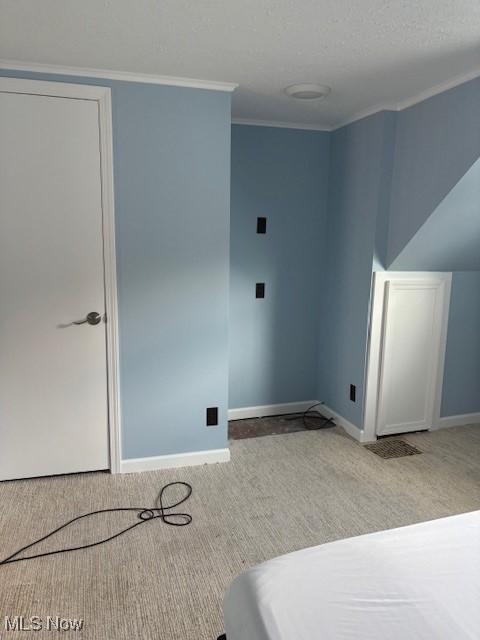 206 Fowler, Cortland, OH 44410 - laundry area featuring light carpet, crown molding, and a textured ceiling