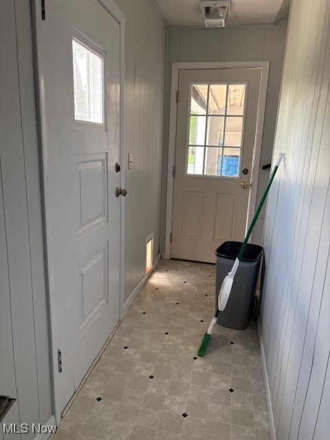 206 Fowler, Cortland, OH 44410 - entryway with healthy amount of natural light, wooden walls, and light floors
