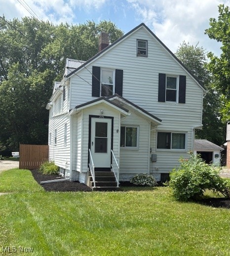 206 Fowler, Cortland, OH 44410 - view of front of home with entry steps, a front lawn, and a chimney