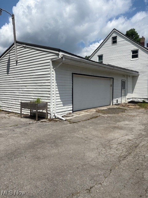 206 Fowler, Cortland, OH 44410 - view of side of property with asphalt driveway and a garage
