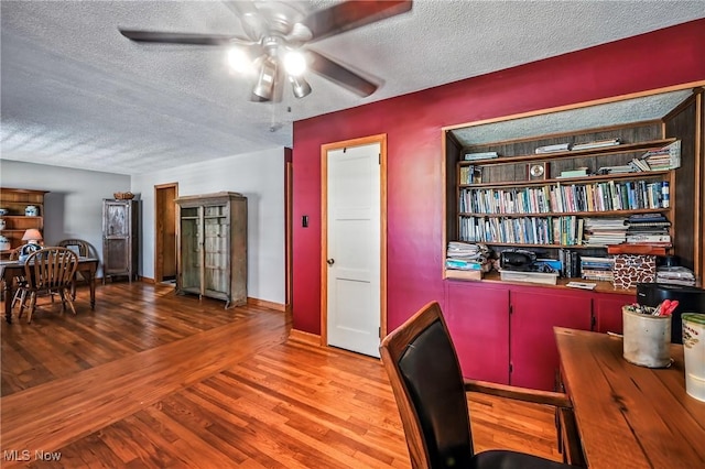 1683 Ridgewood Dr, Salem, OH 44460 - home office featuring a textured ceiling, ceiling fan, and wood finished floors