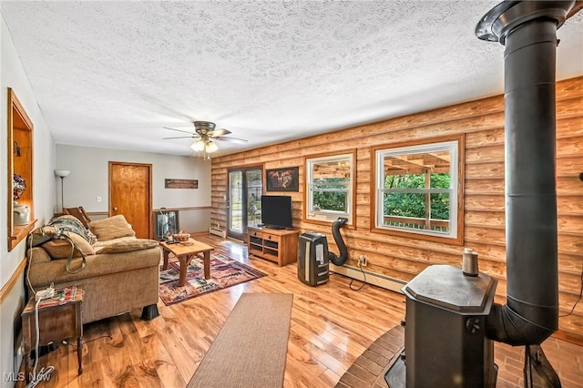 1683 Ridgewood Dr, Salem, OH 44460 - living area featuring rustic walls, ceiling fan, a textured ceiling, baseboard heating, and wood finished floors