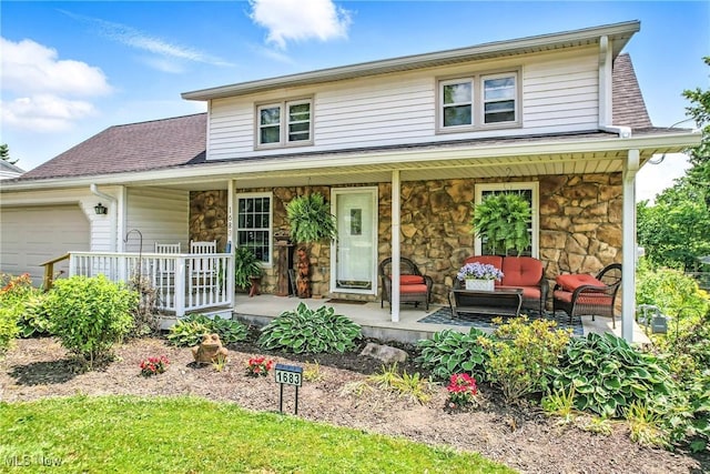 1683 Ridgewood Dr, Salem, OH 44460 - view of front of house featuring covered porch, a garage, stone siding, and an outdoor living space