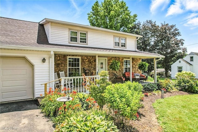 1683 Ridgewood Dr, Salem, OH 44460 - view of front of home with covered porch, stone siding, and an attached garage