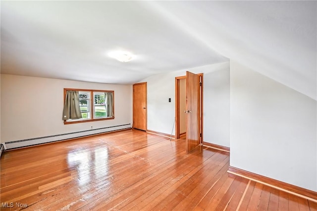 1683 Ridgewood Dr, Salem, OH 44460 - spare room with a baseboard radiator, vaulted ceiling, and light wood-type flooring
