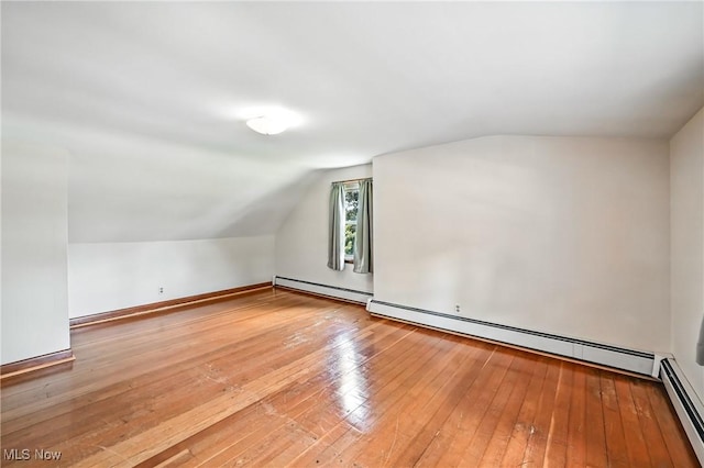 1683 Ridgewood Dr, Salem, OH 44460 - additional living space with lofted ceiling, wood-type flooring, and a baseboard radiator