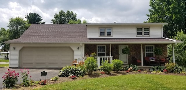 1683 Ridgewood Dr, Salem, OH 44460 - traditional home with a porch, a garage, concrete driveway, a front lawn, and stone siding