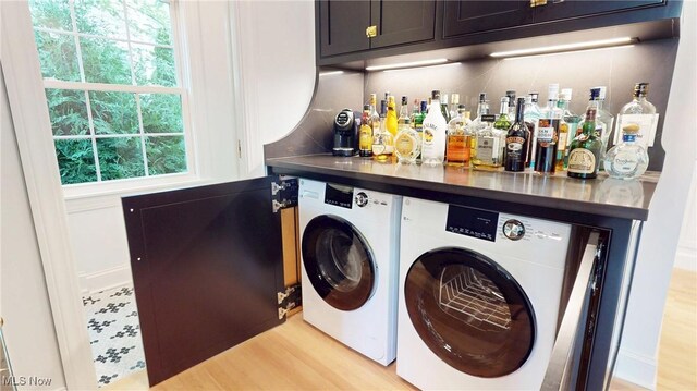 43 S St, Chagrin Falls, OH 44022 - laundry room with washer and dryer, cabinet space, a bar, and plenty of natural light