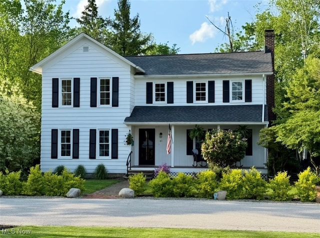 43 S St, Chagrin Falls, OH 44022 - view of front of house featuring a chimney, covered porch, and roof with shingles