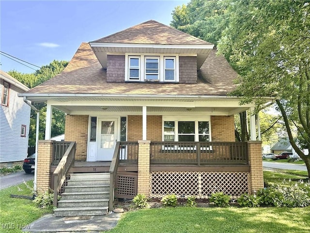 38 Franklin Ave, Niles, OH 44446 - view of front of property featuring a porch, brick siding, and a shingled roof