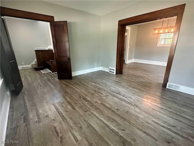 38 Franklin Ave, Niles, OH 44446 - spare room with wood finished floors, a chandelier, and a baseboard heating unit