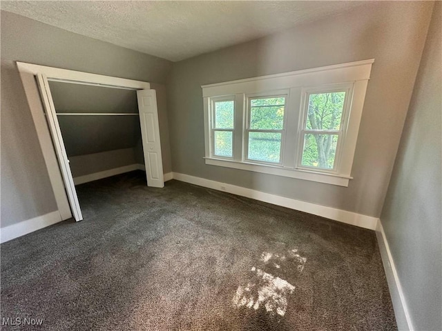 38 Franklin Ave, Niles, OH 44446 - unfurnished bedroom featuring dark colored carpet, a closet, and a textured ceiling