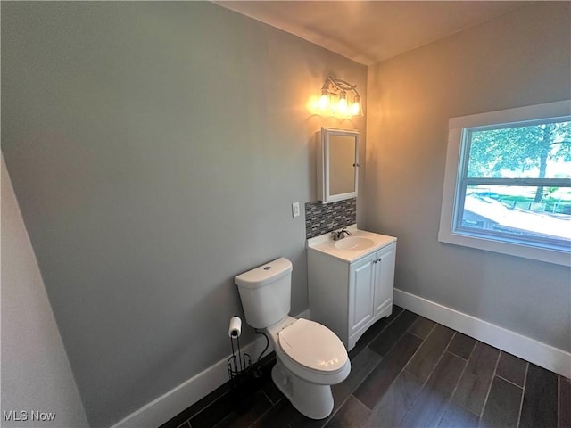 38 Franklin Ave, Niles, OH 44446 - half bathroom featuring vanity, wood tiled floors, and backsplash
