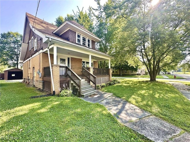 38 Franklin Ave, Niles, OH 44446 - view of front of home with a porch, brick siding, and a front lawn
