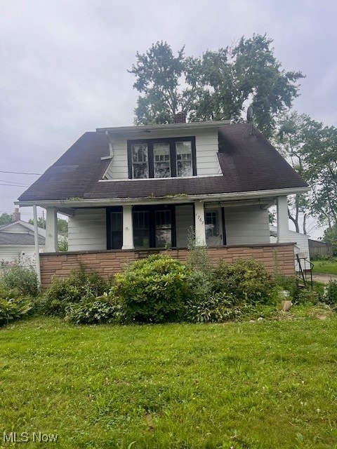 1767 Northfield, Warren, OH 44485 - bungalow with a front yard, a porch, and a chimney