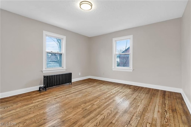 3781 Washington Blvd, University Heights, OH 44118 - unfurnished room featuring radiator and wood finished floors
