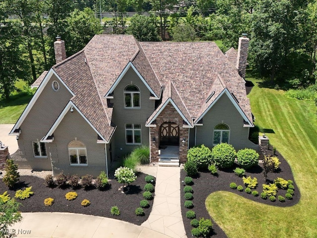 2474 Ginger Wren Rd, Pepper Pike, OH 44124 - view of front of property with a chimney, a front lawn, and brick siding