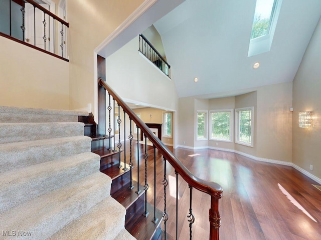 2474 Ginger Wren Rd, Pepper Pike, OH 44124 - stairs with high vaulted ceiling, wood finished floors, a skylight, and recessed lighting