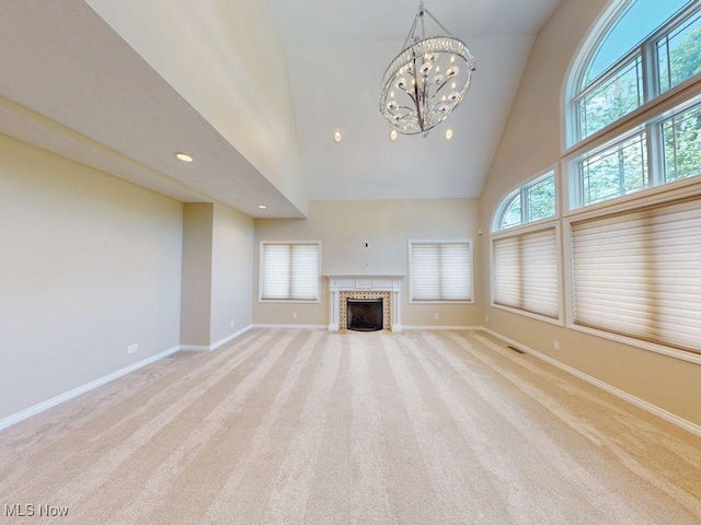 2474 Ginger Wren Rd, Pepper Pike, OH 44124 - unfurnished living room with high vaulted ceiling, light colored carpet, recessed lighting, a fireplace with flush hearth, and a chandelier