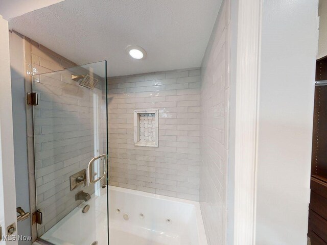 2474 Ginger Wren Rd, Pepper Pike, OH 44124 - bathroom with a combined bath / shower with jetted tub and a textured ceiling